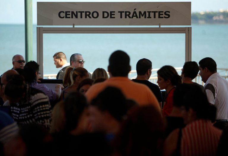 Puerto Rico's already beleaguered middle class are being squeezed by a series of recent economic measures that Gov. Alejandro Garcia Padilla pushed through to try and close a budget deficit as the U.S. territory hobbles through its seventh year of recession. The sign reads in Spanish 