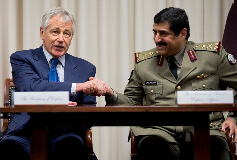 Defense Secretary Chuck Hagel, left, shakes hands with Qatari Defense Minister Hamad bin Ali al-Attiyah, at the Pentagon, Monday, July 14, 2014, during a signing ceremony. (AP Photo/Manuel Balce Ceneta)