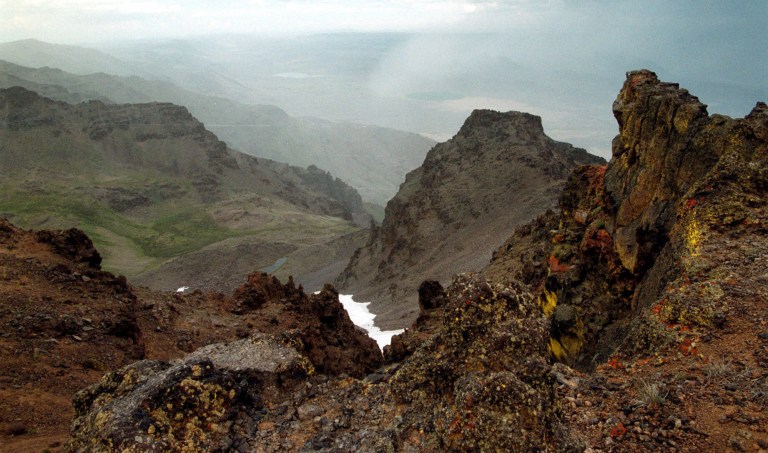 This Aug. 4, 1999 file photo shows a rocky outcrop on Steens Mountain in southeastern Oregon. Dustin Self, 14, of Piedmont, Okla. was missing on the mountain, where a rancher found his abandoned pickup truck on Tuesday, April 18, 2013. The 30-mile long fault block of basalt is the highest point in the desert of southeastern Oregon at 9,773 feet. (AP Photo/The Oregonian, Bob Ellis)