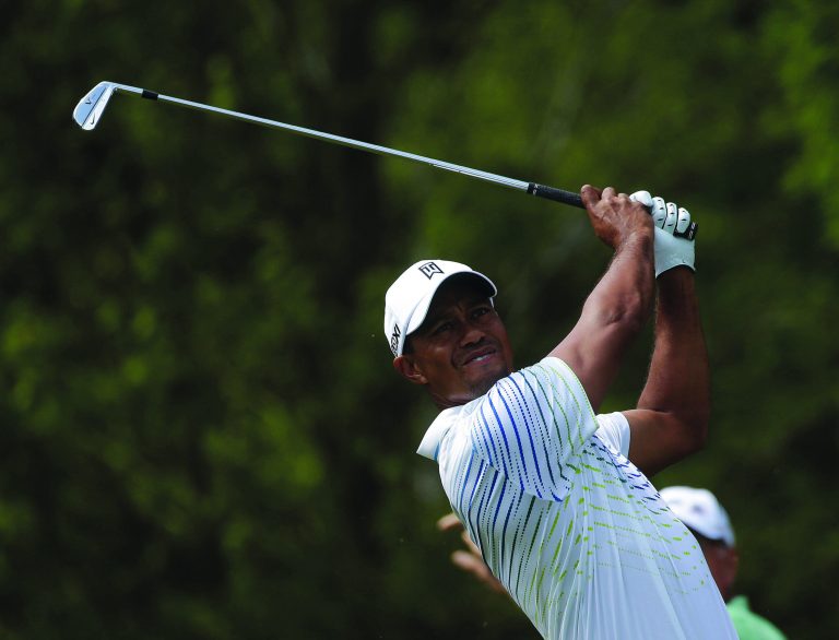 John Bazemore/AP
Tiger Woods finished the first round with a 4-under 66, tying him for the lead with Justin Rose on Thursday.