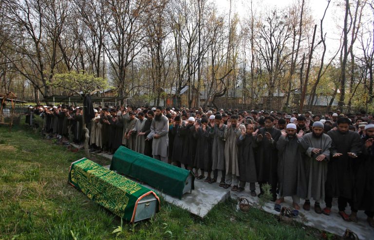 Kashmiri villagers pray by the bodies of Ghulam Nabi, a rural body head of a pro-Indian party and his son Firdous Ahmad during a joint funeral at Batgund village, some 40 kilometers (25 miles) south of Srinagar, India, Tuesday, April 22, 2013. Police say suspected rebels have killed three men in Indian Kashmir ahead of voting in general elections this week. More than a dozen rebel groups have been fighting for Kashmir's independence from India or merger with Pakistan since 1989. (AP Photo/Mukhtar Khan)