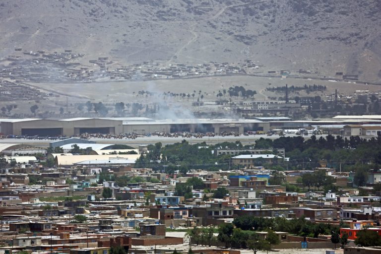 Smoke rises from the Kabul airport after an attack in Afghanistan, Thursday, July 3, 2014. An Afghan official says militants fired two rockets into the military side of the Kabul airport, striking President Hamid Karzai's helicopter as it sat on the tarmac. (AP Photo/Rahmat Gul)