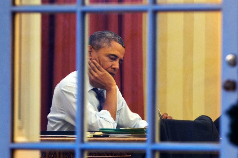 President Barack Obama works at his desk in the Oval Office of the White House in Washington, Monday, Jan. 27, 2014, ahead of Tuesday night's State of the Union speech. (AP Photo/Jacquelyn Martin)