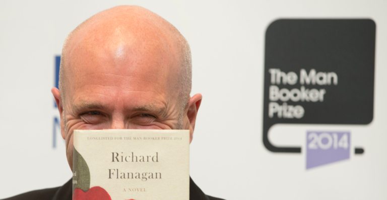 Winner of the Man Booker for fiction 2014 Australian author Richard Flanagan, author of 'The Narrow Road to the Deep North', poses for the camera after winning the prize at the Guildhall in London, Tuesday, Oct. 14, 2014. (AP Photo/Alastair Grant)