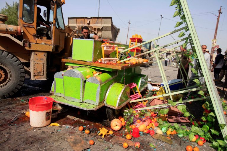 A street vendor inspects his destroyed juice cart at the scene of a bomb attack at Sadr City in Baghdad, Iraq, Tuesday, May 28, 2013. A bomb left on a Baghdad minibus and a suicide truck bomb north of the Iraqi capital killed and wounded scores of people on Tuesday, officials said. The attacks followed a particularly bloody day that left more than 70 people dead. (AP Photo/ Karim Kadim)
