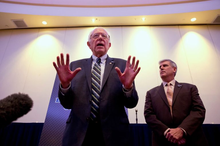 Democratic presidential candidate Sen. Bernie Sanders, I-Vt., left, speaks to the media after speaking at the 2015 International Association of Sheet Metal, Air, Rail, and Transportation Workers Conference, Tuesday, July 28, 2015, in Washington. (AP Photo/Jacquelyn Martin)