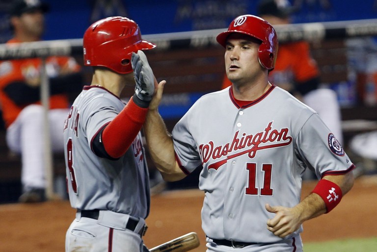Washington Nationals' Ryan Zimmerman (11) is congratulated by Danny Espinosa after Zimmerman scored on a base hit by Michael Morse against the Miami Marlins in the sixth inning of a baseball game in Miami, Sunday, July 15, 2012. The Nationals won 4-0. (AP Photo/Alan Diaz)