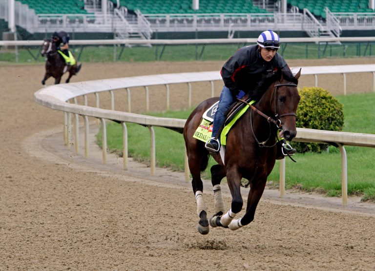 Exercise rider Faustino Aguilar takes Kentucky Derby hopeful Medal Count for a morning workout at Churchill Downs Wednesday, April 30, 2014, in Louisville, Ky. (AP Photo/Garry Jones)