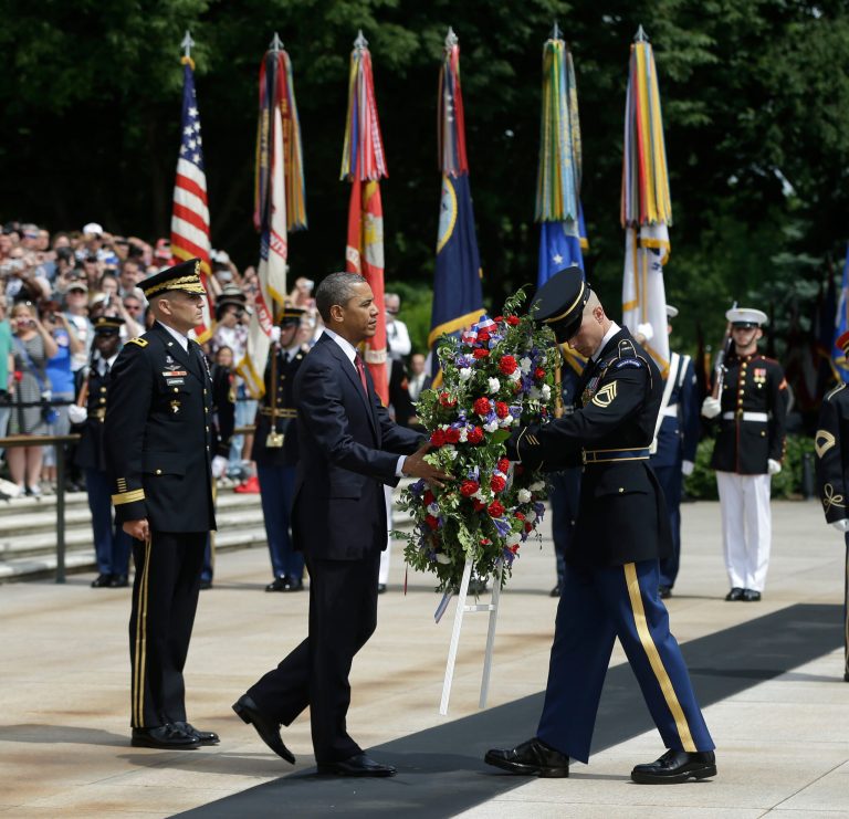 President Barack Obama, center, participates in the wreathlaying ceremony at the Tomb of the Unknowns with Maj. Gen. Michael S. Linnington, left, Commander of the U.S. Army Military District of Washington, at Arlington National Cemetery on Memorial Day, May 27, 2013, in Arlington, Va. (AP Photo/Pablo Martinez Monsivais)