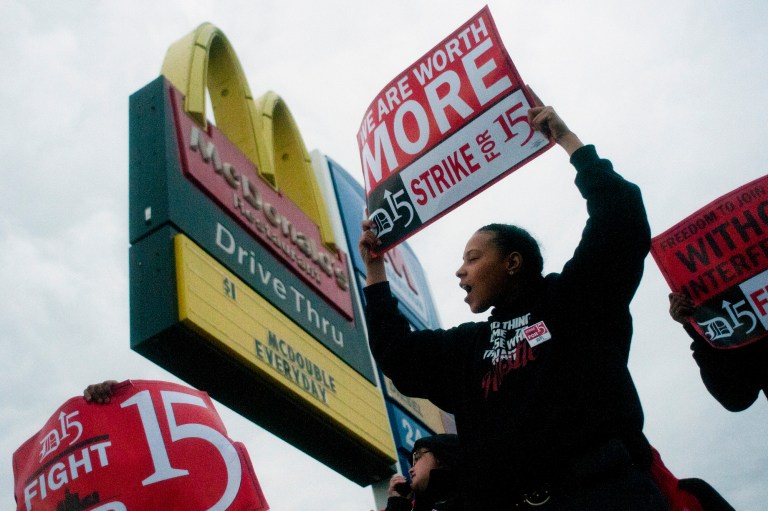 Fast-food worker Michelle Osborn, 23, of Flint shouts out chants as she and a few dozen others strike outside of McDonald's on Wednesday, July 31, 2013 in Flint. (AP/Jake May)