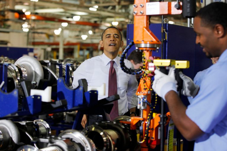   President Barack Obama watches a worker during a visit to the heavy duty engines line at the Daimler Detroit Diesel plant in Redford, Mich., Monday, Dec. 10, 2012. (AP Photo/Charles Dharapak)  