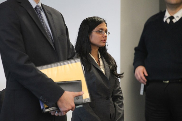 Former state lab chemist Annie Dookhan, center, stands in Middlesex Superior Court. The Boston Bar Association, a membership organization of about 10,000 attorneys, said more oversight is needed to make sure the state doesn't have a repeat of the crisis caused by Dookhan, whose misconduct at a state drug lab has jeopardized thousands of drug convictions. (AP Photo/The Boston Globe, Suzanne Kreiter, Pool)