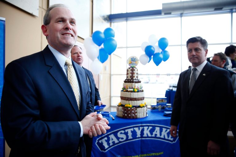 Tastykake President Paul Ridder, left, accompanied by Pennsylvania Lt. Gov. Jim Cawley, invites attendees to have birthday cake, as Tastykake marks its 100th anniversary Tuesday, Feb. 25, 2014, in Philadelphia. Tastykake made 100 cakes on its first day of business in 1914. Now, it produces nearly 5 million cakes, doughnuts, cookies and pies each day. (AP Photo/Matt Rourke)