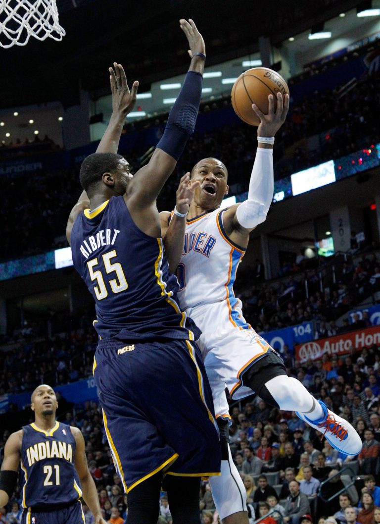   Oklahoma City Thunder guard Russell Westbrook (0) shoots in front of Indiana Pacers center Roy Hibbert (55) in the first quarter of an NBA basketball game in Oklahoma City, Sunday, Dec. 9, 2012. (AP Photo/Sue Ogrocki)  