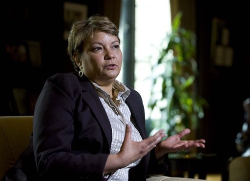 FILE- In this April 17, 2012 file photo, Environmental Protection Agency (EPA) Administrator Lisa Jackson gestures during an interview with The Associated Press at EPA Headquarters in Washington. In its first major regulation since the election, the Obama administration will impose a new air quality standard that reduces by 20 percent the maximum amount of soot released into the air from smokestacks, diesel trucks and other sources of pollution. The Environmental Protection Agency is set to announce the new standard on Friday, meeting a court deadline in a lawsuit by 11 states and public health groups.  (AP Photo/Kevin Wolf, File)