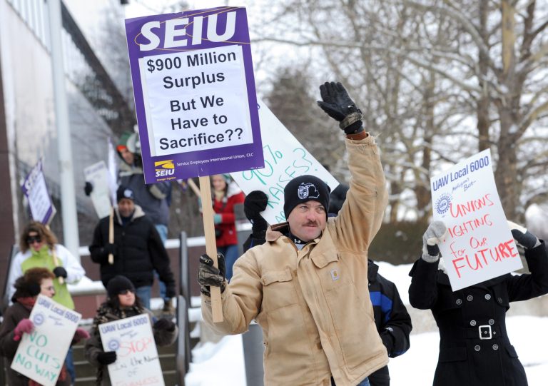 State workers protest as meetings continued, Dec. 18 between state employees and the Michigan Civil Service Commission in Lansing, Mich. (AP/Lansing State Journal, Greg DeRuiter)