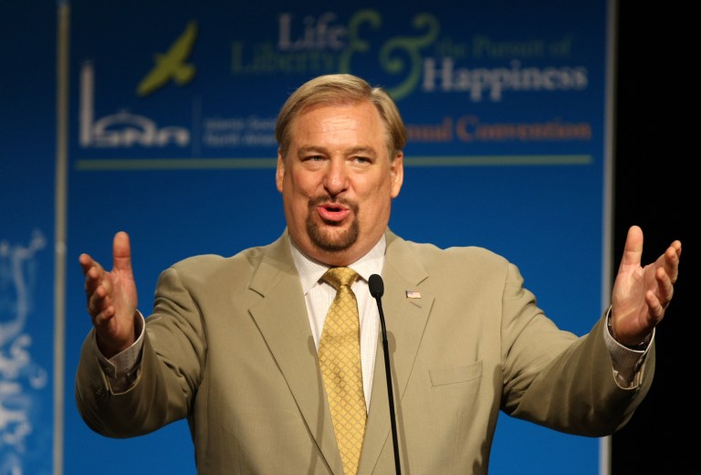 FILE - In this Saturday, July 4, 2009 file photo, evangelical pastor Rick Warren gestures as he speaks at the Islamic Society of North America's 46th annual convention in Washington. The American evangelical pastor Rick Warren, who addressed a big rally in the Rwandan capital of Kigali on Sunday, Aug. 17, 2014, during thanksgiving celebrations marking 20-years since the genocide in which more than 800,000 people were killed, told The Associated Press that he hopes to expand his ministry to East Africa. (AP Photo/Luis M. Alvarez, File)