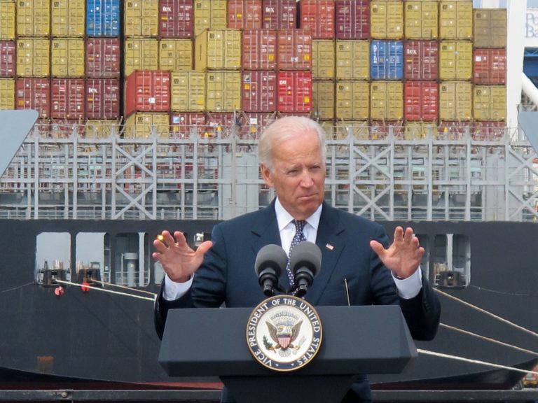 FILE - In this Monday, Sept. 9, 2013, file photo, cargo is unloaded from a vessel at the Port of Baltimore as Vice President Joe Biden speaks. The government reports on the U.S. trade deficit for September on Thursday, Nov. 14, 2013. (AP Photo/Brian Witte)