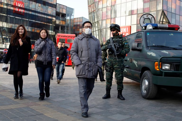 Heavily armed Chinese paramilitary police guard a popular mall in the Sanlitun district of Beijing, China, Thursday, Dec. 24, 2015. (AP Photo/Ng Han Guan)