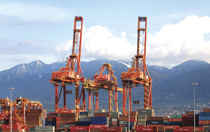 Cargo cranes unload ships at a port. (Photo by Robert Giroux/Getty Images)