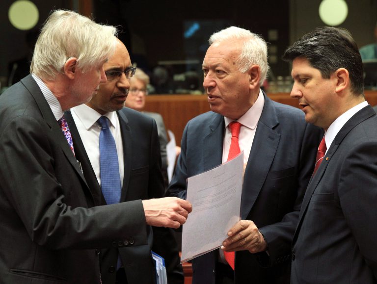 Spain's Foreign Minister Jose Manuel Garcia-Margallo y Marfil, second right, talks with Finland's Foreign Minister Erkki Sakari Tuomioja, left, French Secretary of State for European Affairs Harlem Desir, second left, and Romania's Foreign Minister Titus Corlatean during an EU foreign ministers meeting at the European Council building in Brussels Monday, May 12, 2014. EU foreign ministers discuss the situation in Ukraine. (AP Photo/Yves Logghe)