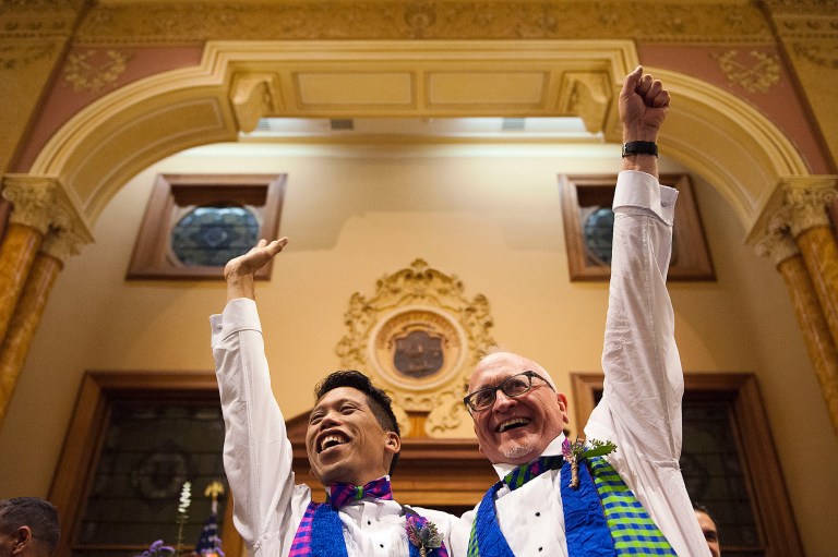 David Gibson, right, and Richard Kiamco of Jersey City become the first official same-sex couple to be married in Jersey City on Monday. (AP/Reena Rose Sibayan)