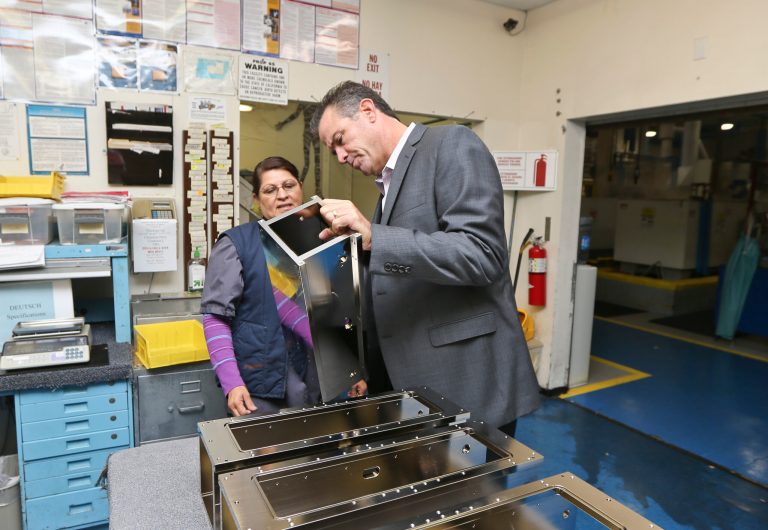 In this Thursday, Oct. 10, 2013, photo, Dale Watkins Jr., President of Sheffield Platers Inc., talks with employee Eva Gasca,  at his factory in San Diego. The Commerce Department reports on orders placed with U.S. factories in November  2013 on Jan. 6, 2014. (AP Photo/Lenny Ignelzi)