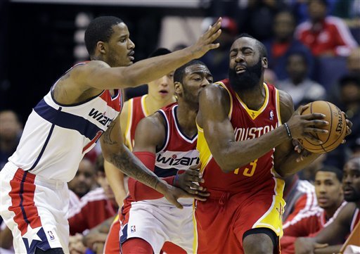 Washington Wizards forward Trevor Ariza (1) and guard John Wall (2) combine on Houston Rockets guard James Harden (13) in the second half of an NBA basketball game, Saturday, Feb. 23, 2013, in Washington. Harden had 27 points, but the Wizards won 105-103. (AP Photo/Alex Brandon)