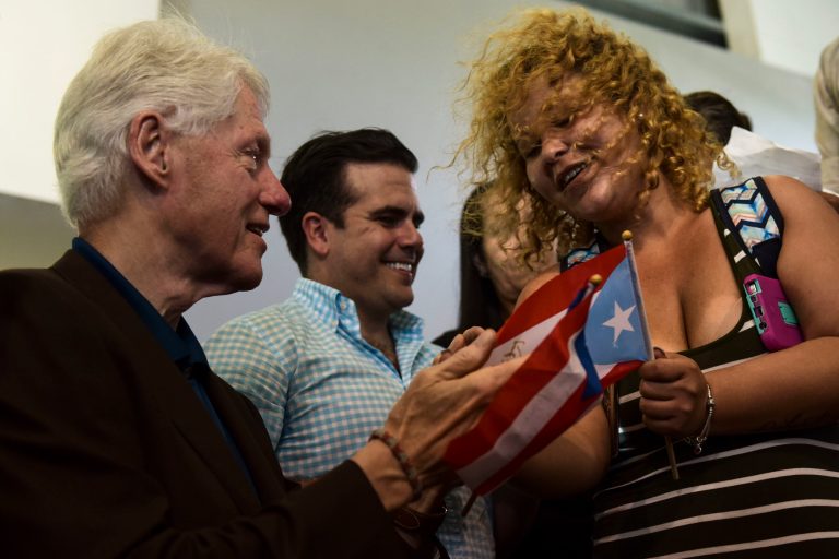 Former President Bill Clinton visits residents at the William Rivera Betancourt Vocational School which was turned into an emergency shelter for families affected by the impact of Hurricane Maria, in Canovanas, Puerto Rico, Monday, Nov. 20, 2017. (AP Photo/Carlos Giusti)