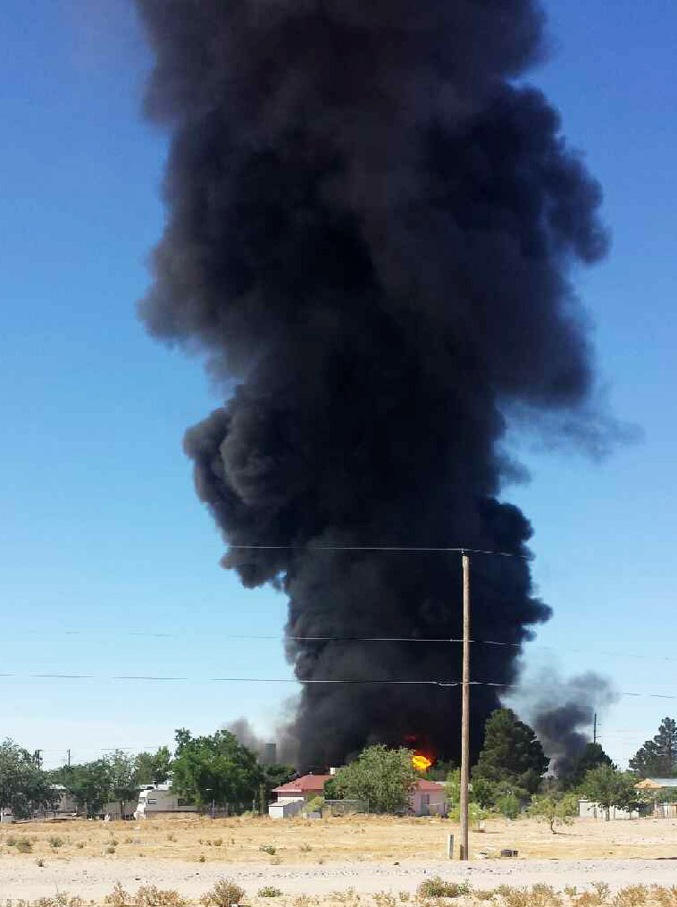 In this handout photo provided by Miguel Favela, smoke rises from a fire at a biofuel facility near Anthony, N.M. on Tuesday, May 27, 2014 prompting an evacuation of an area a half-mile around the plant, authorities said. Dona Ana County officials activated their emergency operations center and declared a hazardous materials emergency, said county spokesman Jess Williams. (AP Photo/Miguel Favela)