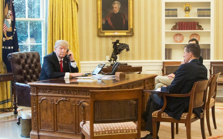 President Donald Trump, left, accompanied by National Security Adviser Michael Flynn, right, and Senior Advisor to the President Jared Kushner, speaks on the phone with King of Saudi Arabia Salman bin Abd al-Aziz Al Saud in the Oval Office at the White House in Washington, Sunday, Jan. 29, 2017. (AP Photo/Manuel Balce Ceneta)