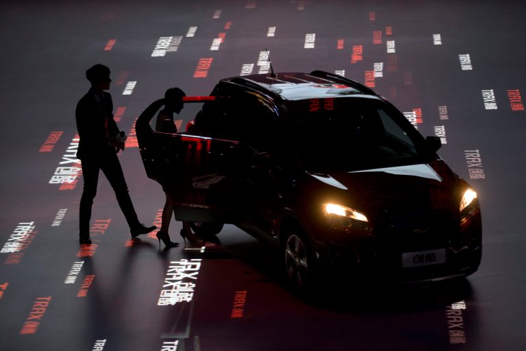 Brand ambassador Taiwanese actor Kai Ko, left and Amber Kuo  step  into a Chevrolet Trax urban SUV during the China launch of the car ahead of Auto China 2014 in Beijing, China, Saturday, April 19, 2014. The Trax will go on sale in China starting at RMB 119,900 or $19,300. (AP Photo/Ng Han Guan)