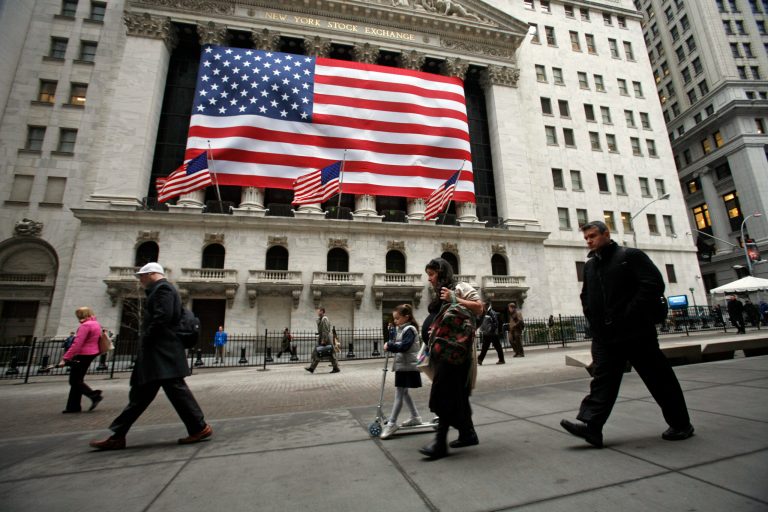 People pass in front of the New York Stock Exchange in this Monday, March 9, 2009 photo. Worries over Russian troops amassing near the Ukraine border caused a sharp sell-off in global stock markets on Wednesday Aug. 6, 2014. (AP Photo/Mark Lennihan)