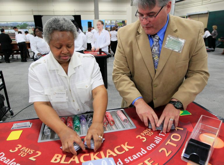   Sophia Hargrave practices shuffling a deck of cards with the help of trainer Charles Zascavage, Tuesday, Nov. 27, 2012, at Horseshoe Casino Cincinnati in Cincinnati. One of the safest bets at the new casino set to open this spring is that cheaters will be among the gamblers, targeting dealers who have only dealt cards in a training room. (AP Photo/Al Behrman)  