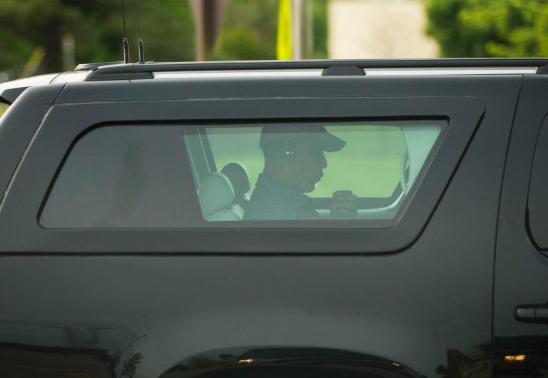 President Barack Obama inside his armored SUV as his motorcade makes his way back to Washington after playing golf at Andrews Air Force Base Friday following a shooting at the White House. (AP Photo/Pablo Martinez Monsivais)