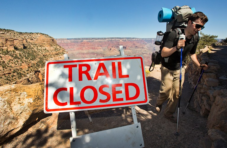   Grand Canyon Park Closed-10-1-2013- Sebastian Ramirez, 27, of Austin, Texas, hikes out of the Bright Angel Trail in Grand Canyon National Park, Tuesday afternoon. Ramirez spent the night with friends in the bottom of the Canyon at Bright Angel Campground. Beginning at 6 am, visitors were told the park was closed and they could not visit. (AP Photo/The Arizona Republic, Tom Tingle) MARICOPA COUNTY OUT; MAGS OUT; NO SALES MBO  