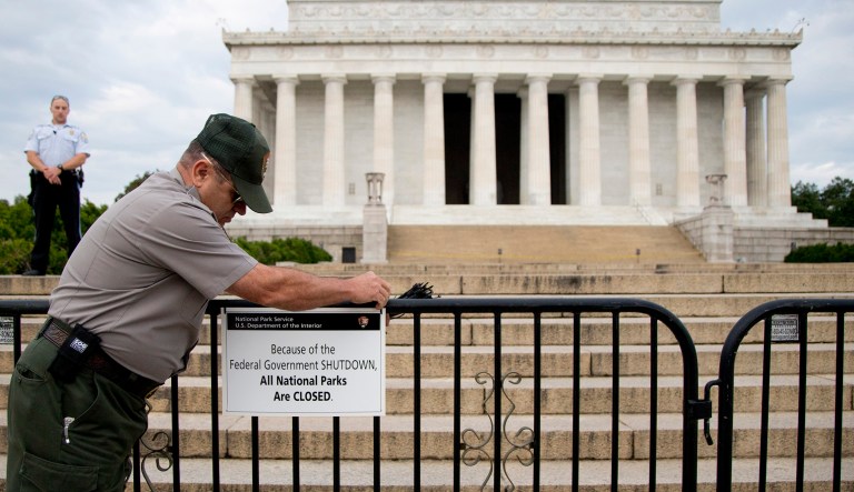A National Park Service employee posts a sign on a barricade closing access to the Lincoln Memorial in Washington during the 2013 government shutdown.