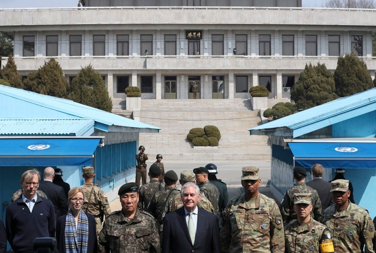 U.S. Secretary of State Rex Tillerson, center, stands with U.S. Gen. Vincent K. Brooks, third right, commander of the United Nations Command, Combined Forces Command and United States Forces Korea, and South Korean Deputy Commander of the Combined Force Command Gen. Leem Ho-young, third left, as North Korean soldiers look at the south side at the border village of Panmunjom, which has separated the two Koreas since the Korean War, South Korea, Friday. (AP Photo/Lee Jin-man, Pool)