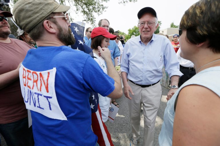 Democratic presidential candidate Sen. Bernie Sanders greets local residents before walking in a Fourth of July parade, Saturday, July 4, 2015, in Waukee, Iowa. (AP Photo/Charlie Neibergall)