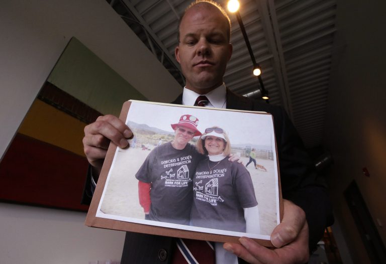 Attorney Paxton Guymon holds a photograph of Jim and Jan Harding following a news conference Thursday, Aug. 21, 2014, in Salt Lake City. Jan Harding, 67, drank sweet tea containing a toxic cleaning chemical, severely burning her mouth and throat at a Utah restaurant after an employee mistook the substance for sugar and mixed it into a dispenser. Harding is listed in good condition at a Salt Lake City hospital as she continues to improve. Authorities say a worker at Dickey's Barbecue in South Jordan unintentionally put the chemical cleaning compound in a sugar bag last month.  (AP Photo/Rick Bowmer)