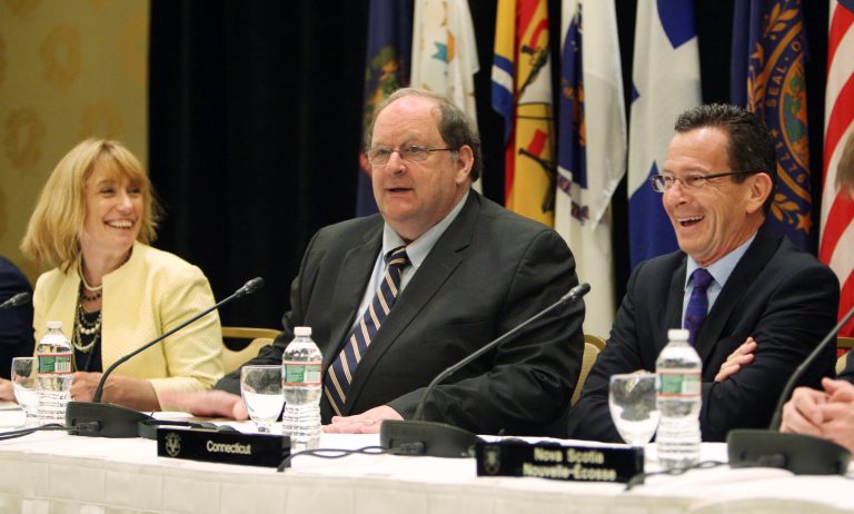 Gov. Maggie Hassan, D-N.H., left, and Gov. Dannel Malloy, D-Ct., right, laugh as Premier Tom Marshell of Newfoundland and Labrador, center,  arrives for a press conference following the New England Governors and eastern  Canadian Premiers 38th annual conference , Monday, July 14, 2014. in Bretton Woods, N.H.  They are wrapping up a two-day meeting in New Hampshire focused on regional cooperation.(AP Photo/Jim Cole)