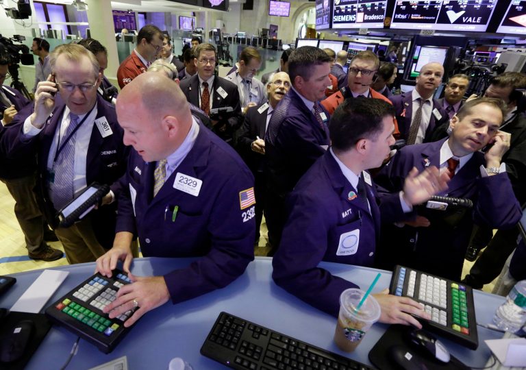 Traders gather at posts on the floor of the New York Stock Exchange Wednesday. Stocks edged lower in early trading on Wall Street Wednesday as investors waited for word from the Federal Reserve. (AP Photo/Richard Drew)