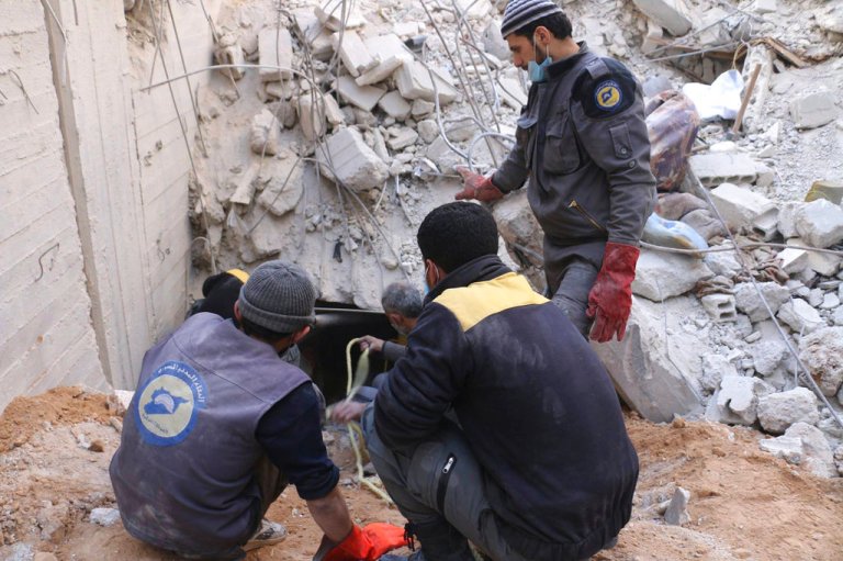 This photo released Feb. 20, 2018 by the Syrian Civil Defense group known as the White Helmets, shows members of the Syrian Civil Defense group working to remove victims from under the rubble of a damaged shelter that was hit in airstrikes and shelling by Syrian government forces, in Ghouta, a suburb of Damascus, Syria. Thousands of Syrians huddle in basements and underground shelters across eastern Ghouta, outside Damascus, hiding from the horror raining down from Syrian army jets that almost never leave the skies. (Syrian Civil Defense White Helmets via AP)