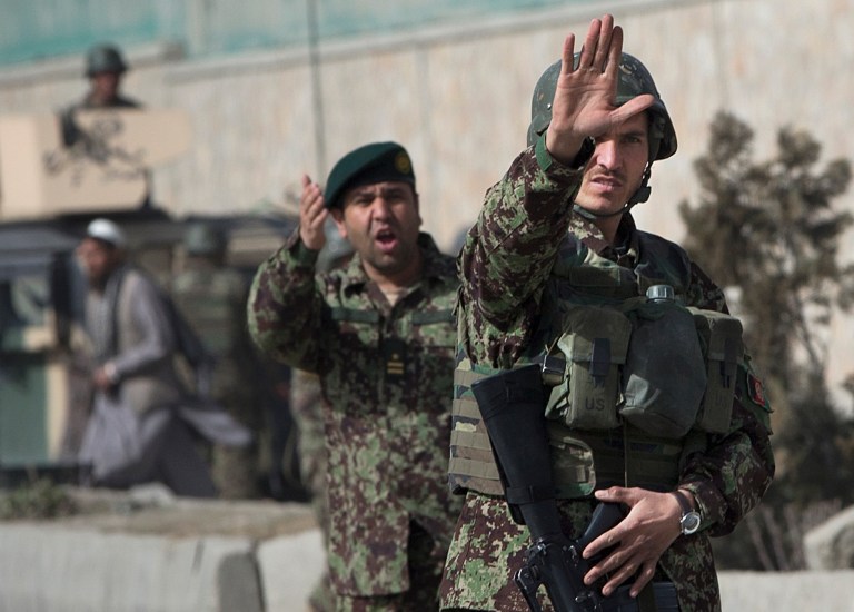 Afghan Army soldiers stop people from advancing the Afghan Defense Ministry after a suicide bomber on a bicycle struck outside the ministry, killing at least nine Afghan civilians as U.S. Defense Secretary Chuck Hagel visited Kabul, Afghanistan, Saturday, March 9, 2013. (AP Photo/Anja Niedringhaus)