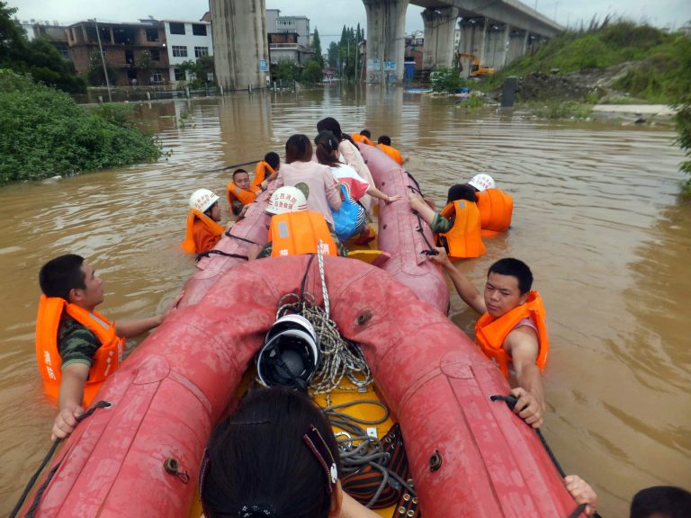 In this photo taken Sunday May 25, 2014, Chinese rescue workers evacuate residents by boats through flood waters in Shangli county in central China's Jiangxi province. Flooding over the past week in China's south has killed 37 people, left six missing, and forced almost half a million people from their homes, the government said Monday, May 26. (AP Photo) CHINA OUT