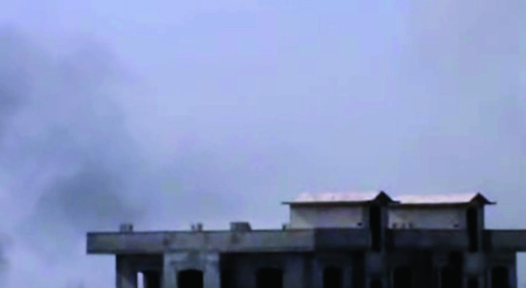 In this image taken from video obtained from the Shaam News Network, which has been authenticated based on its contents and other AP reporting, smoke rises from buildings after warplanes shell the town of Jobar, in Homs, Syria, on Thursday, Jan. 24, 2013. (AP Photo/Shaam News Network via AP video)