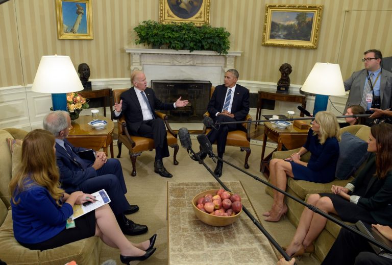 President Barack Obama listens as Vice President Joe Biden speaks in the Oval Office of the White House in Washington, Monday, Oct. 17, 2016, about the release of the Cancer Moonshot Report. Dr. Jill Biden listens at right. (AP Photo/Susan Walsh)