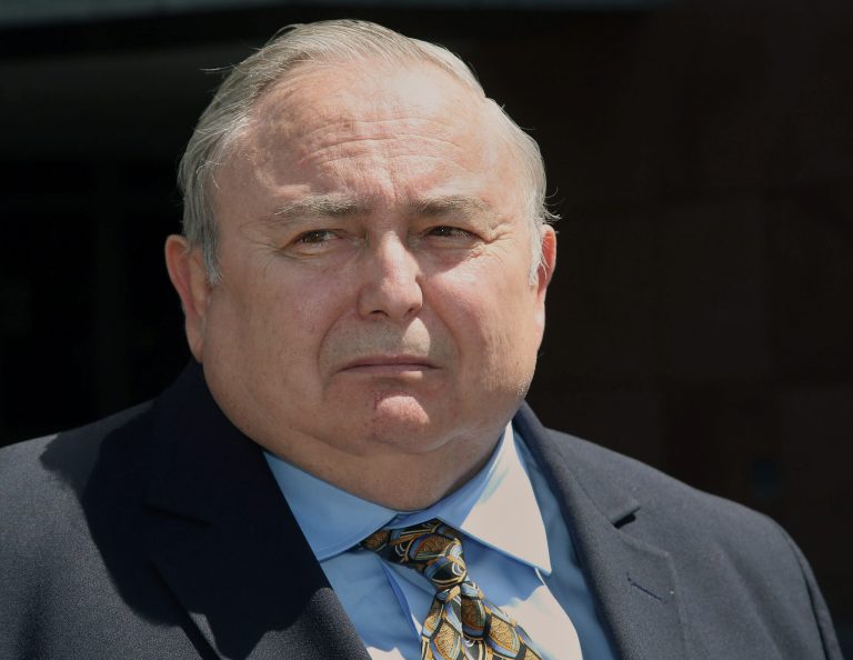 Former Bell city manager Robert Rizzo, listens to questions from the media, as he leaves the Edward R. Roybal Federal building and United States courthouse Monday. Rizzo was sentenced to 33 months in prison for income tax evasion. (AP Photo/Nick Ut)
