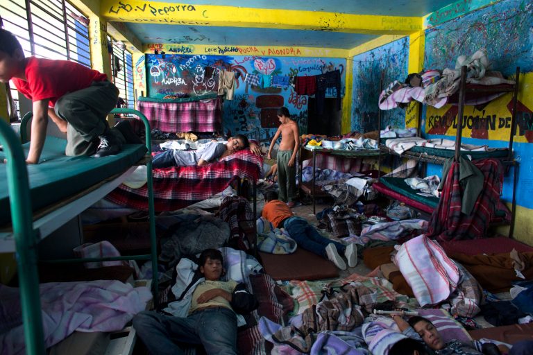 In this Thursday, July 17, 2014 photo, boys watch television in their room at The Great Family group home, in Zamora, Mexico. For more than six decades, poor parents struggling to support their children or raise troubled youths sent them to the group home in western Mexico run by a woman who gained a reputation as a secular saint. On July 15, heavily armed federal police and soldiers raided the home and arrested nine caretakers, including the 79-year-old woman known as Mama Rosa. (AP Photo/Rebecca Blackwell)