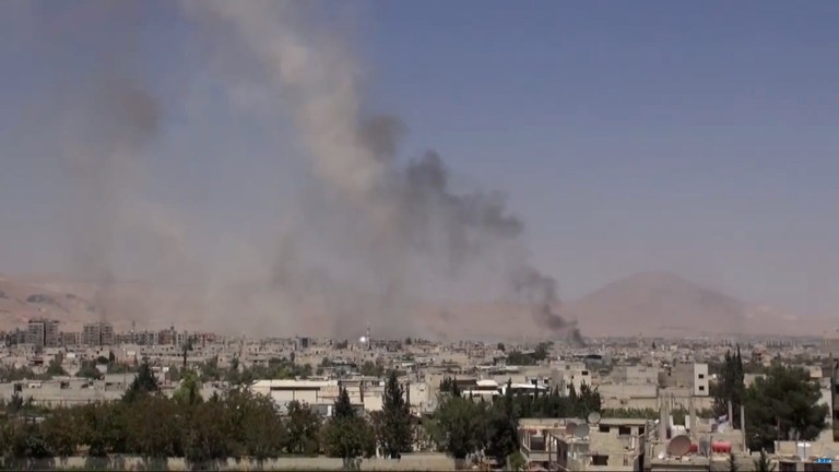 This image from video posted by the Shaam News Network on Sunday, Aug. 16, 2015, shows smoke riding from Syrian government airstrikes in Douma, a suburb of Damascus, Syria. (Shaam News Network via AP video)